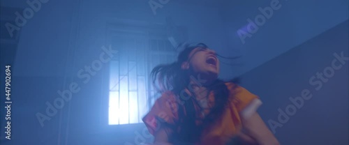 crazy girl  in the interrogation room in handcuffs