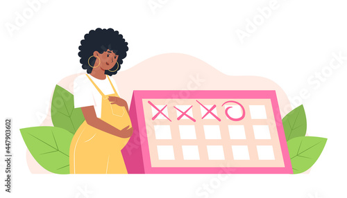 Happy pregnant woman stands near the calendar, planned appointment with an obstetrician-gynecologist