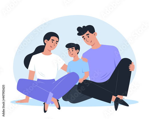 Happy family sitting on the floor and hugging