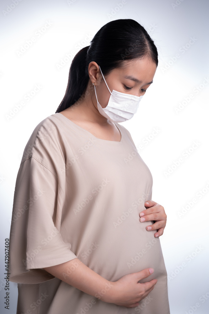 Pregnant asian woman in medical mask for protect coronavirus (covid-19) Pregnant asian woman in medical mask for protect coronavirus (covid-19)