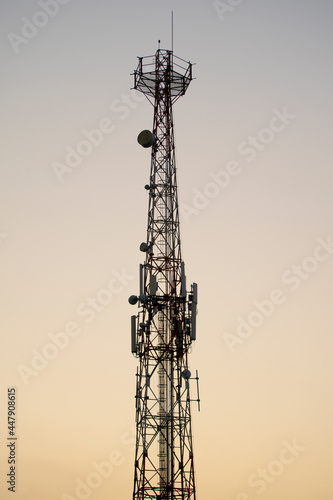 Communications tower with sunset sky background  (ID: 447908615)