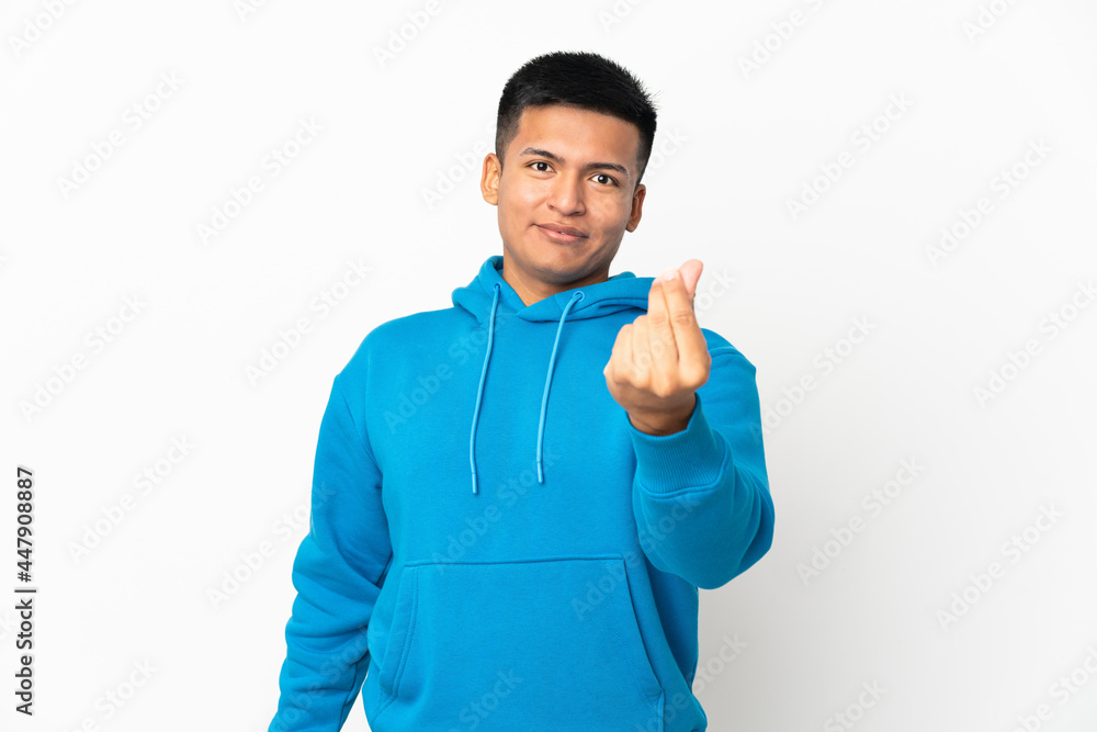 Young Ecuadorian man isolated on white background making money gesture Young Ecuadorian man isolated on white background making money gesture