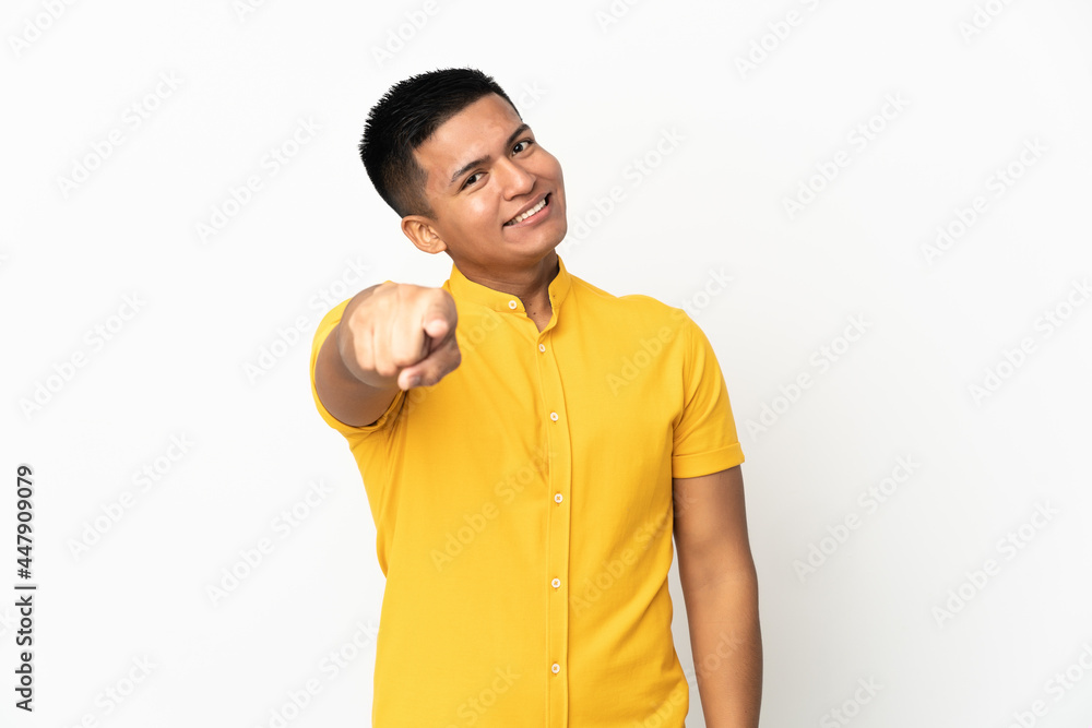Young Ecuadorian man isolated on white background pointing front with happy expression Young Ecuadorian man isolated on white background pointing front with happy expression