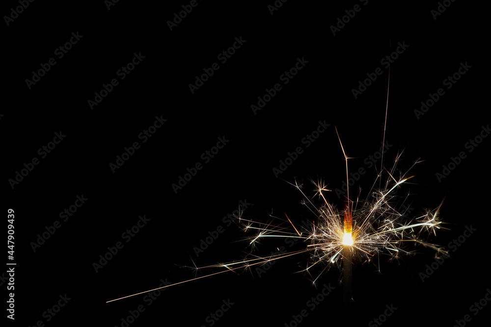 sparkler on black background with copy space