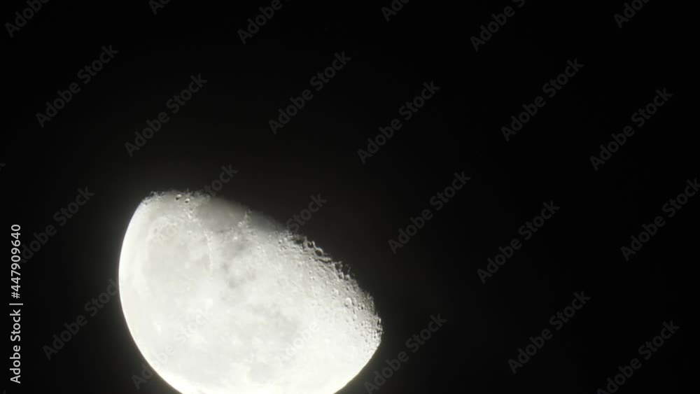 Bright moon disk (little more than half) move across night sky from bottom-left to upper-right side, time lapse shot. Light and transparent clouds quickly fly over in middle of clip Bright moon disk (little more than half) move across night sky from bottom-left to upper-right side, time lapse shot. Light and transparent clouds quickly fly over in middle of clip