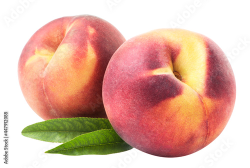 Two ripe peaches with green leaves on a white background. isolated