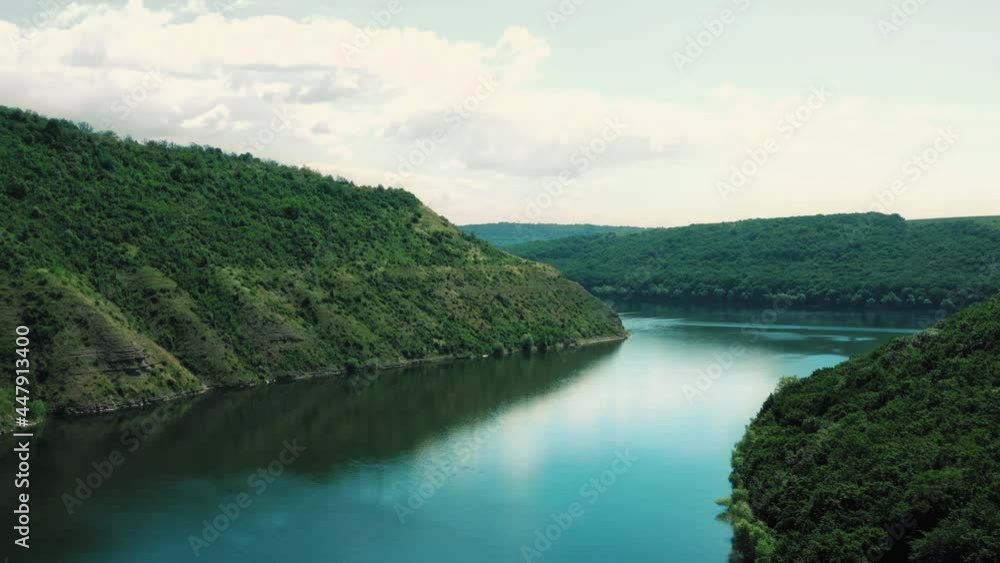 Landscape of nature with wide river flows between forest hills. Aerial view of beautiful wild nature. Clean, Fresh air. Bakota Bay area. Drone footage above water. Hillside. Landscape of nature with wide river flows between forest hills. Aerial view of beautiful wild nature. Clean, Fresh air. Bakota Bay area. Drone footage above water. Hillside.