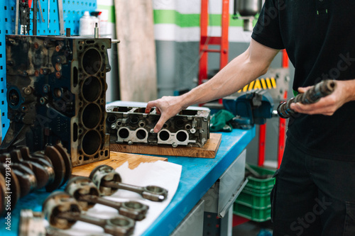 Mechanic checking car parts in the work shop