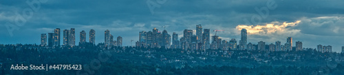 Panoramic view of Metrotown cityscape on cloudy sky background