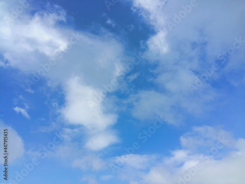 Blue background with white clouds in the foreground.