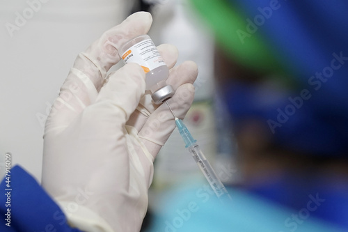 Doctor holding a syringe with liquid sinovac vaccines. Concept fight against virus covid-19 corona virus.