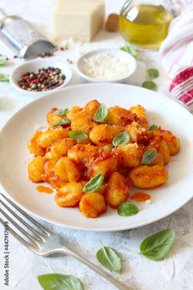 Traditional Italian potato gnocchi with tomato sauce, parmesan cheese and fresh basil. Top view. Traditional Italian potato gnocchi with tomato sauce, parmesan cheese and fresh basil. Top view.