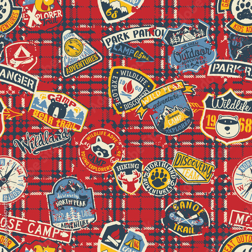 Cute mountain camp and wildlife adventure badges patchwork with grunge tartan plaid background vector seamless pattern 