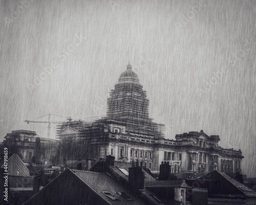Black and white shot of a rainy day with rain pouring down the palais the justice
