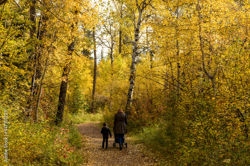 Mother and son walking on a path in Autumn