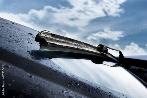Fototapeta Closeup of wet windshield wiper, wipping windscreen outside
