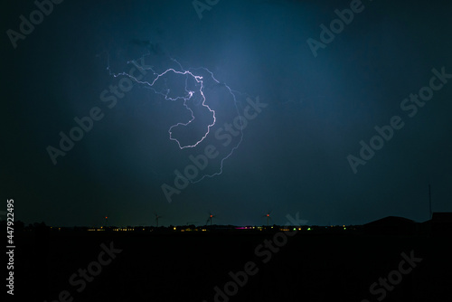 Freakishly shaped lightning bolt high in the sky photo