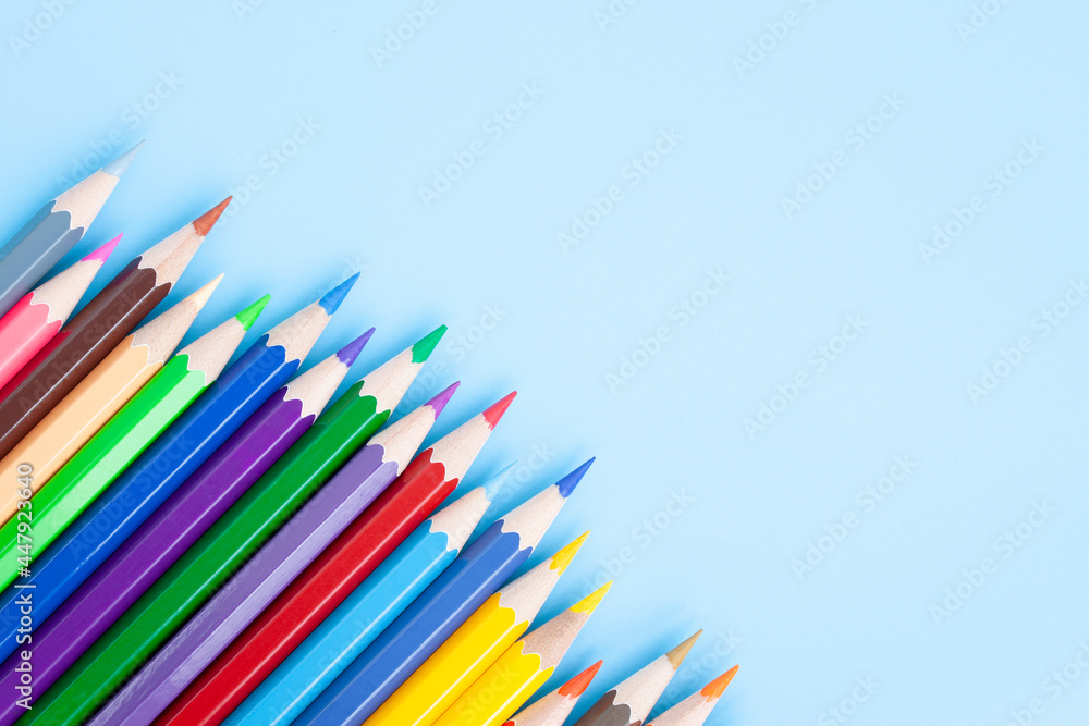 Colorful color pencils, fresh, happiness, back to school, art, drawing, flat lay isolated on blue background.