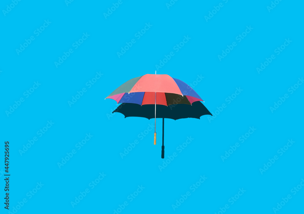 Top view, Single rainbow umbrella isolated on cyan background for stock photo or design, invesment, business, summer concept