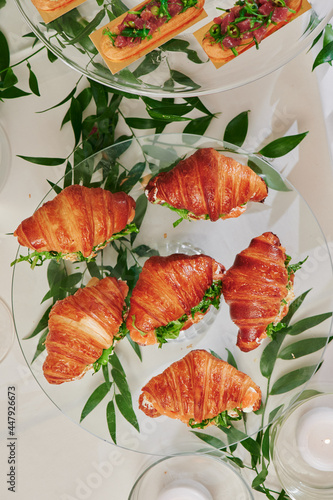 Mini croissants with filling on the festive table. Buffet, catering. High quality photo