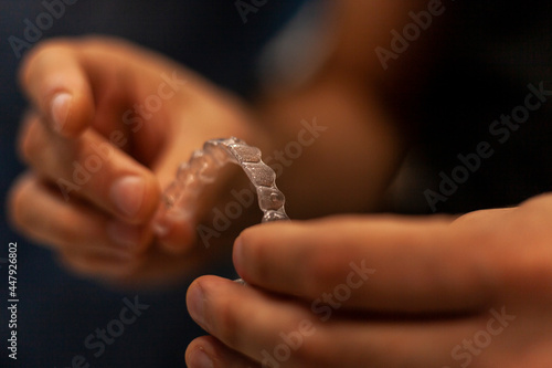 Orthodontist holds in his hands invisaling alienators, invisible orthodontic technique photo