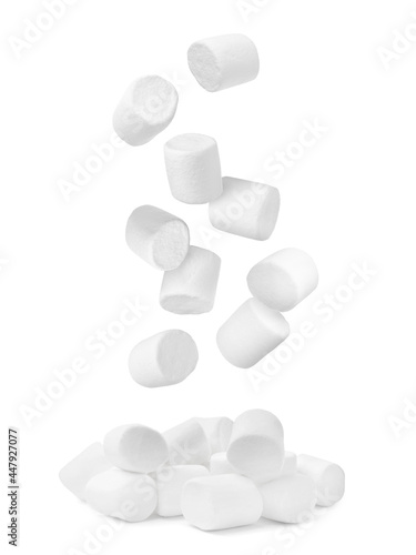 Delicious sweet puffy marshmallows flying on white background