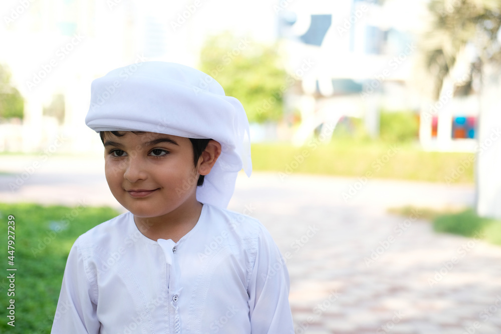 Young boy wearing Kandura. Emirati Arab concept. Portrait of Arabic kid Young boy wearing Kandura. Emirati Arab concept. Portrait of Arabic kid