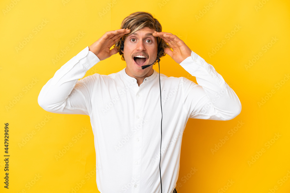 Telemarketer man working with a headset isolated on yellow background with surprise expression Telemarketer man working with a headset isolated on yellow background with surprise expression