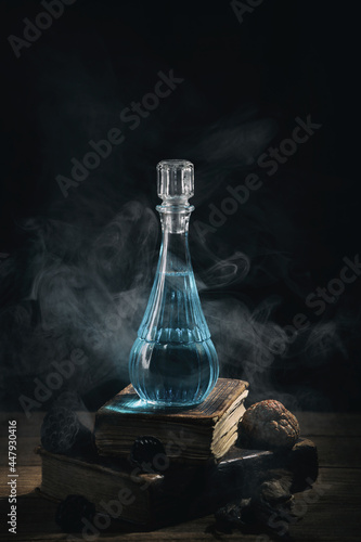 Set of sorcery books and blue magic potion with smoke. Mana potion. Magic and wizardry concept.
