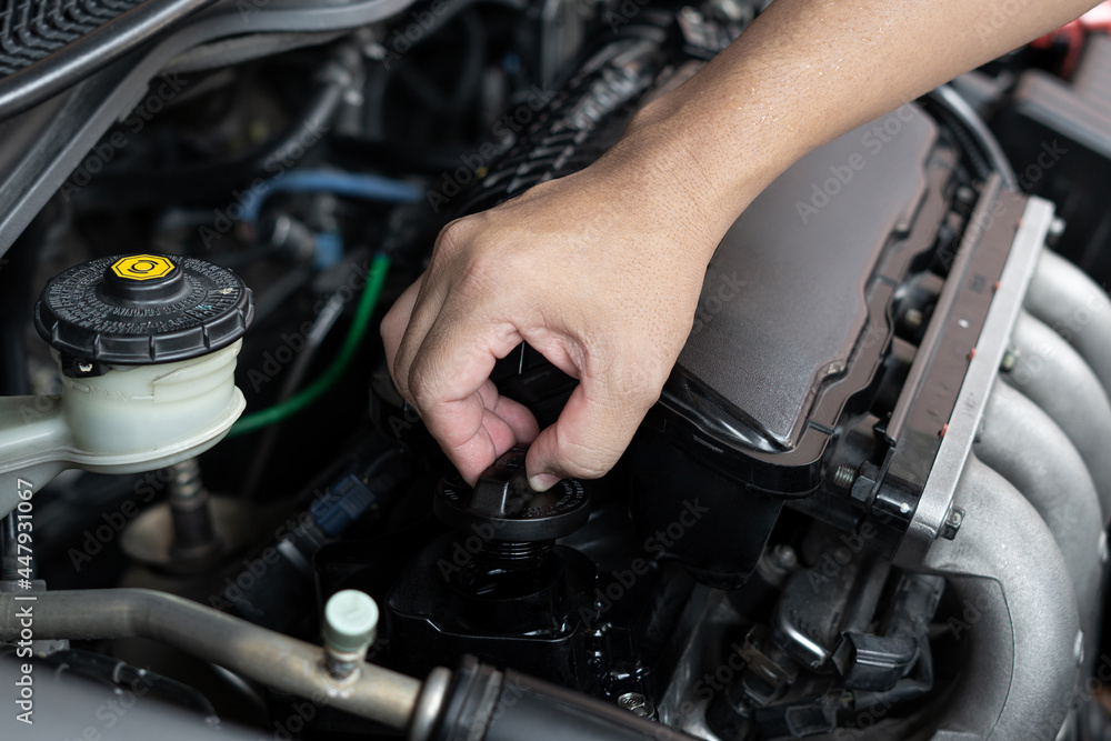 Fototapeta premium Car technician man use screwdriver remove bolt in engine room service and maintenance concept