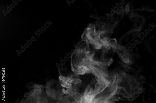 white smoke on black background for overlay effect. a realistic smoke effect for creating an intense nuance in a photo.