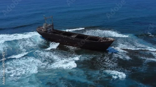 Aerial drone footage of abandoned ship shipwreck in Paphos Cyprus island with waves photo