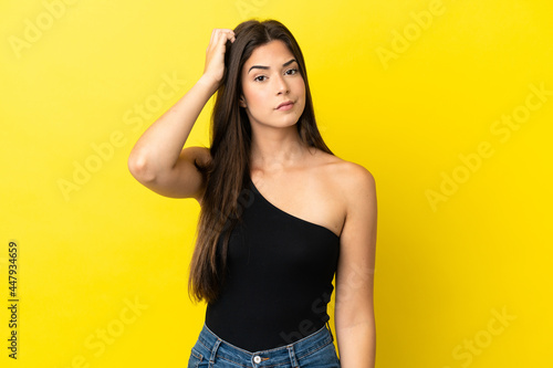 Young Brazilian woman isolated on yellow background with an expression of frustration and not understanding