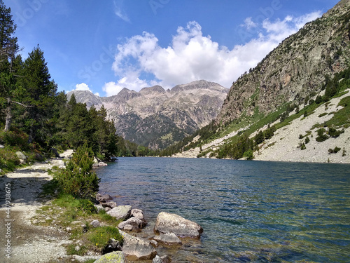 Landscape in the National Park of Aigüestortes and Lake San Mauricio. View of the Lake Llong and glacier lateral moraine. Pyrenees Mountains. Catalonia. Spain.