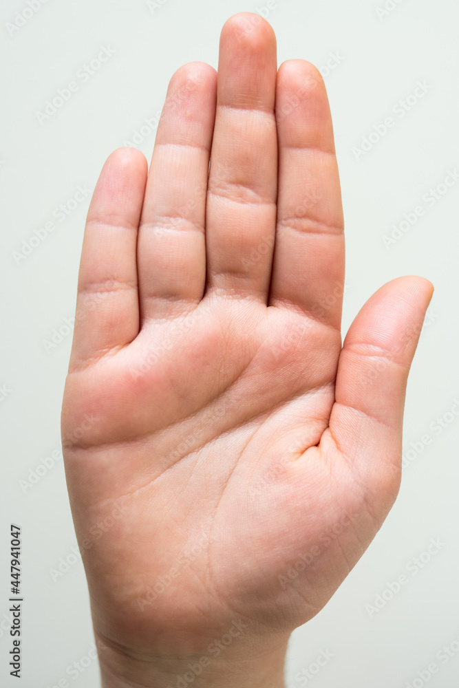 Caucasian hand showing her palm on a white background Caucasian hand showing her palm on a white background
