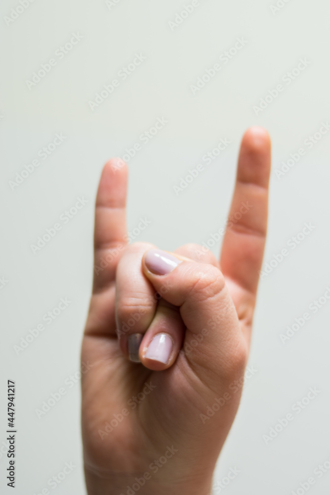 Naklejka premium Hand making a rock symbol on a white background