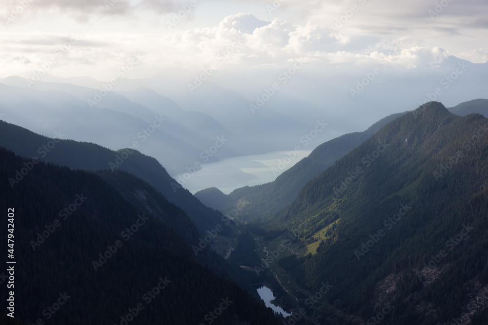 Aerial View from Airplane of a Valley in Canadian Mountain Landscape. Dramatic Sunny Sunset. Howe Sound between Squamish and Vancouver, British Columbia, Canada.