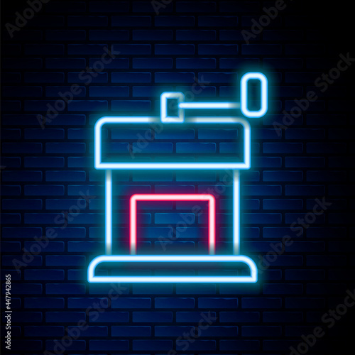 Glowing neon line Manual coffee grinder icon isolated on brick wall background. Colorful outline concept. Vector