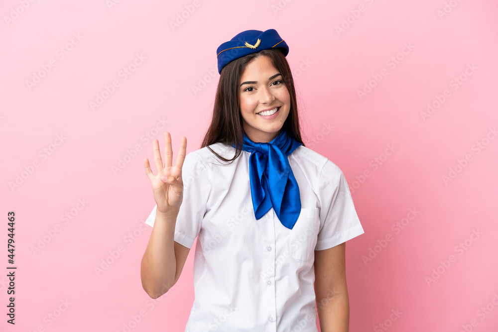 Airplane stewardess Brazilian woman isolated on pink background happy and counting four with fingers Airplane stewardess Brazilian woman isolated on pink background happy and counting four with fingers