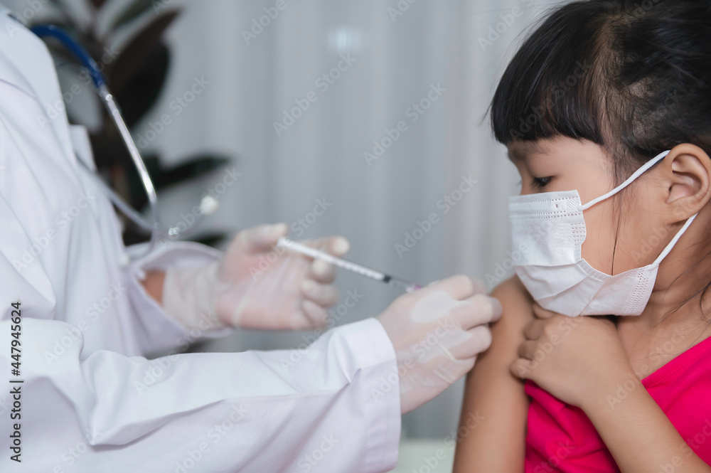 Asian doctor injection vaccine for protecting virus covid-19 to a girl wear medical mask,People are Girls are vaccinated against influenza every year. Asian doctor injection vaccine for protecting virus covid-19 to a girl wear medical mask,People are Girls are vaccinated against influenza every year.