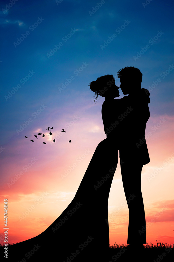 Bride and groom kissing silhouette at sunset