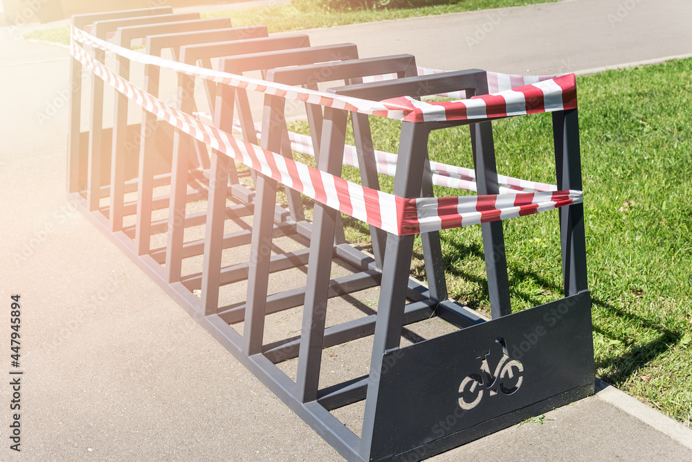 An empty bicycle parking lot wrapped in barrier tape. Bicycle parking is prohibited. An empty bicycle parking lot wrapped in barrier tape. Bicycle parking is prohibited.