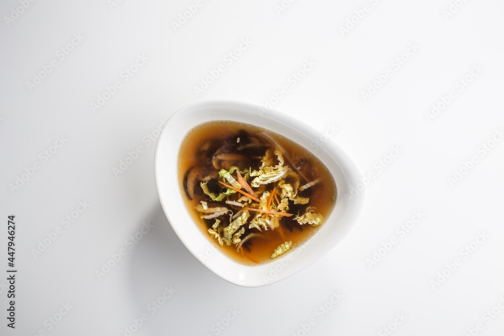 Miso soup with shiitake mushrooms isolated on white background