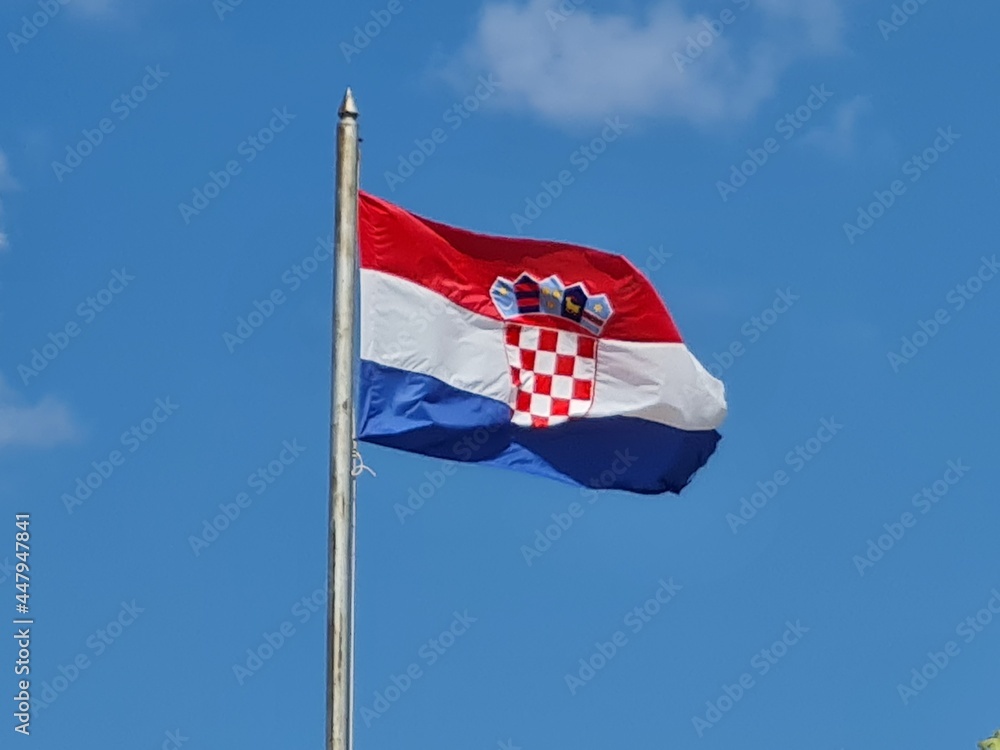 Croatian flag on blue sky. Country flag against sky. Flags of the world Croatian flag on blue sky. Country flag against sky. Flags of the world