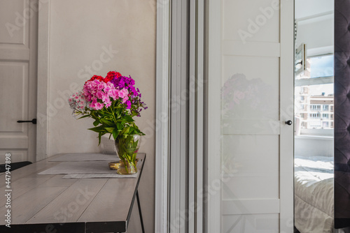 Divided room  table with flowers  wardrobe