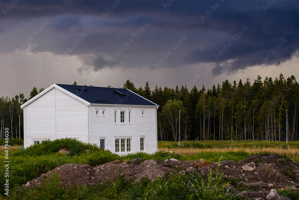 White suburb house in stormy weather White suburb house in stormy weather
