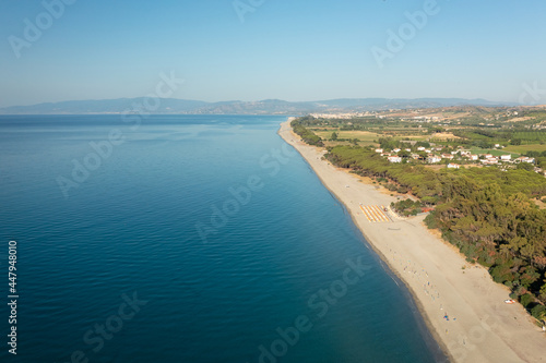 Aerial view of beautiful sea and beach at sunny day, seascape and hill mountain on backgrond, Simeri Mare, Calabria, Southern Italy