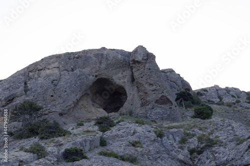 cave in a mountain range in the morning on a sunny day