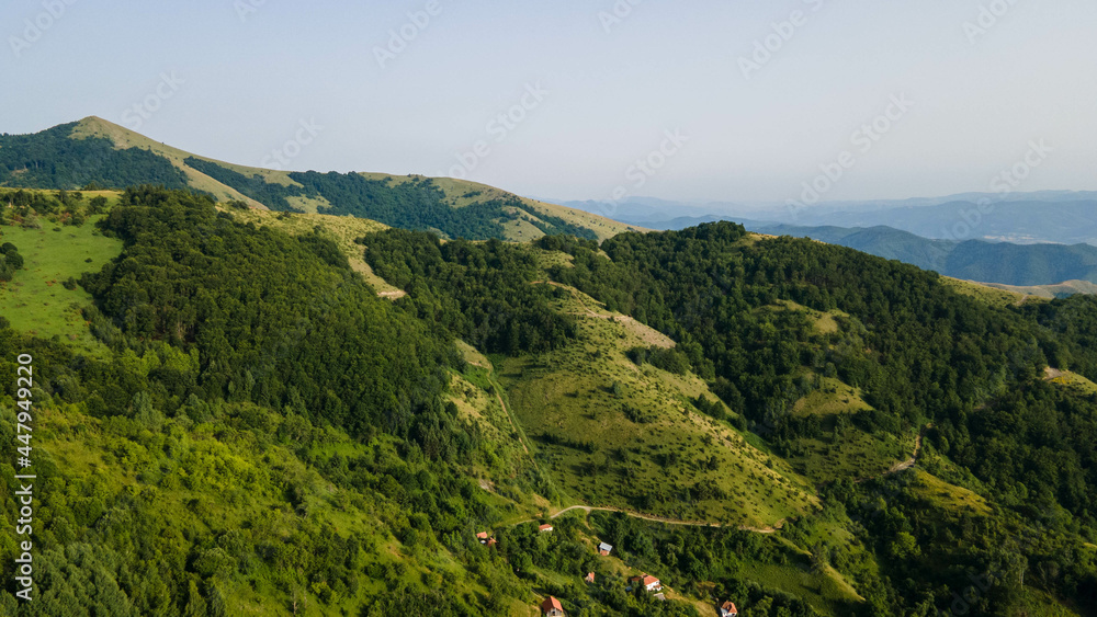 Aerial view of mountains covered with coniferous forests. Aerial View Landscape Mountain. Breathtaking aerial view of the tall mountains covered by the forest.