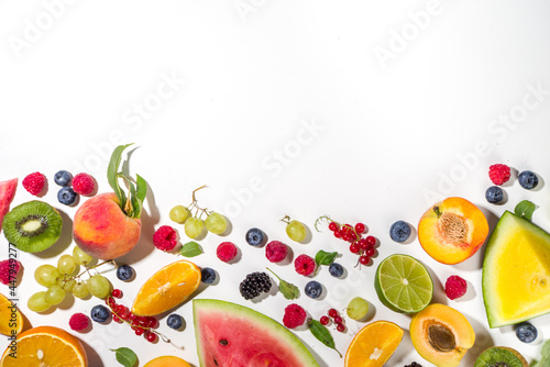 Fototapeta Naklejka Na Ścianę i Meble -  Summer vitamin food concept, various fruit and berries watermelon peach plum apricots blueberry currant, flat lay on white background top view copy